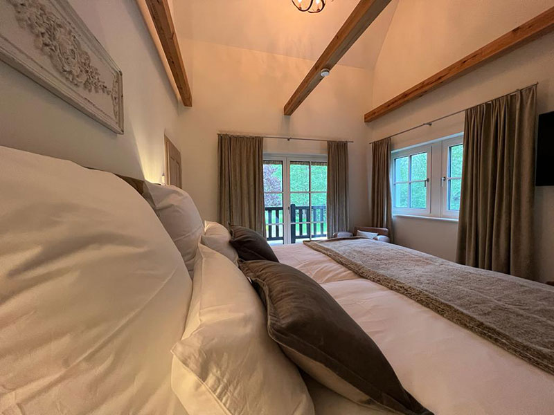 Spreewaldchalet - Ihre Auszeit im Spreewald in einem exklusiven Chalet und Ferienhaus | Doppelbett mit Blick ins Grüne